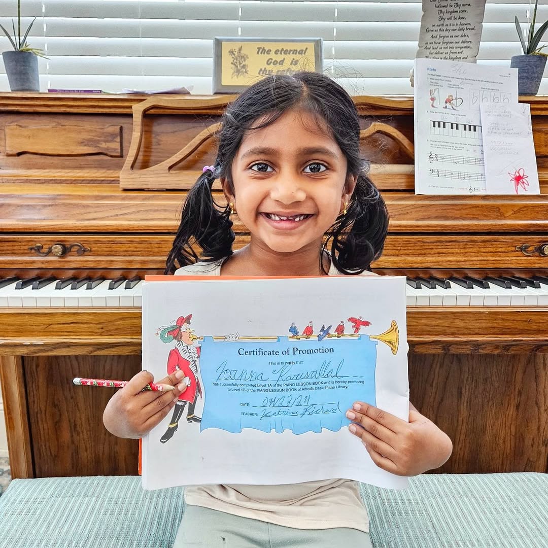A student holding her certificate of promotion